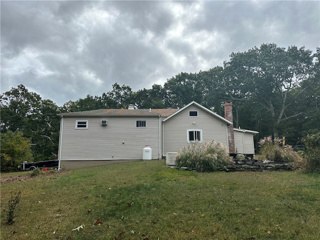 rear view of property with a yard