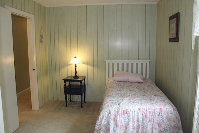 carpeted bedroom with wooden walls