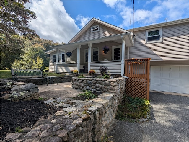 view of front of property featuring a garage and a porch