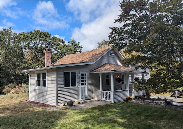 bungalow featuring a front lawn and covered porch