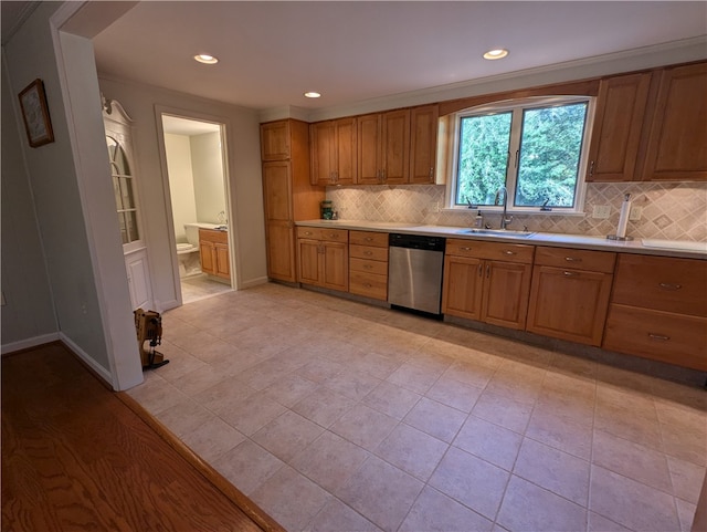 kitchen with backsplash, stainless steel dishwasher, sink, and light tile patterned floors