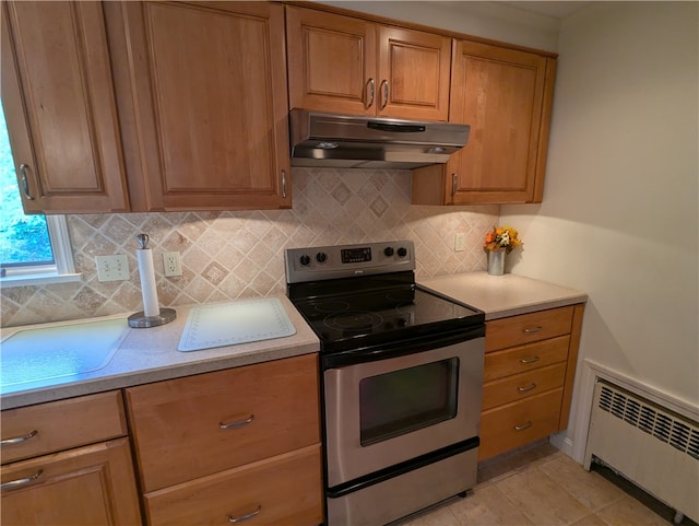 kitchen with stainless steel range with electric cooktop, radiator, light tile patterned flooring, and tasteful backsplash