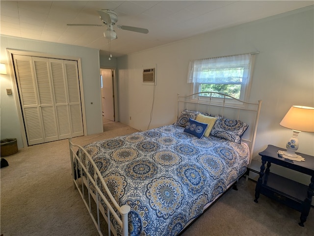 bedroom with carpet, ceiling fan, a wall unit AC, and a closet