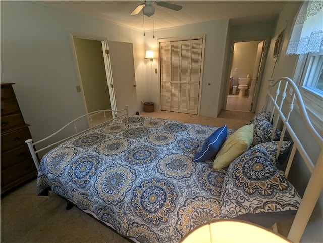 carpeted bedroom featuring ceiling fan, ensuite bathroom, and a closet