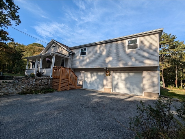 view of front of house featuring a porch and a garage