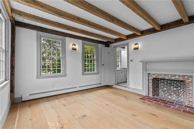 unfurnished living room featuring a brick fireplace, baseboard heating, beam ceiling, and light hardwood / wood-style flooring