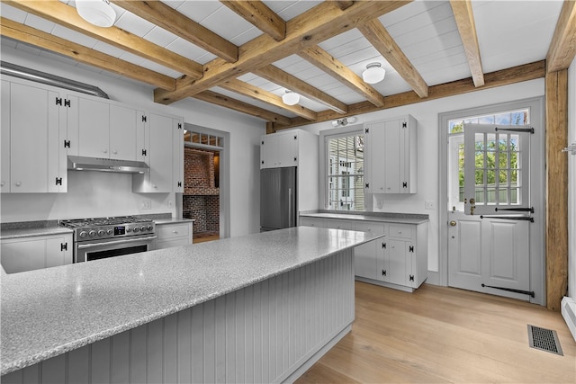 kitchen featuring light hardwood / wood-style flooring, stainless steel appliances, white cabinets, and beamed ceiling