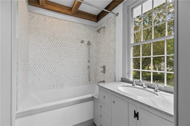 bathroom featuring vanity, beam ceiling, and shower / bathtub combination