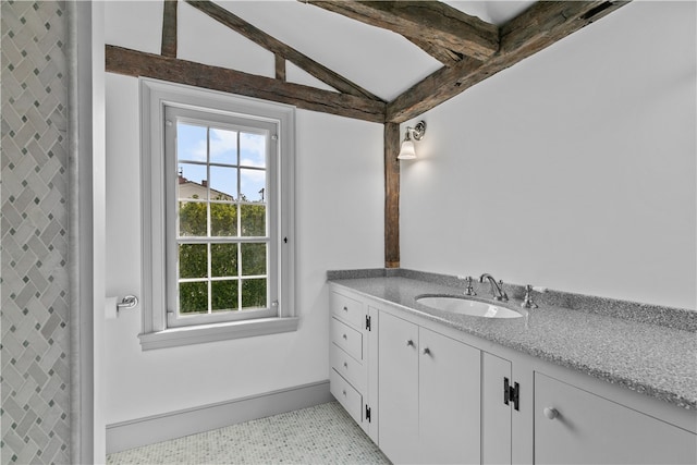 bathroom featuring lofted ceiling, vanity, and tile patterned flooring