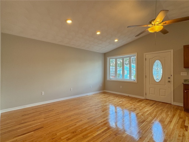 foyer featuring vaulted ceiling, light hardwood / wood-style floors, and ceiling fan