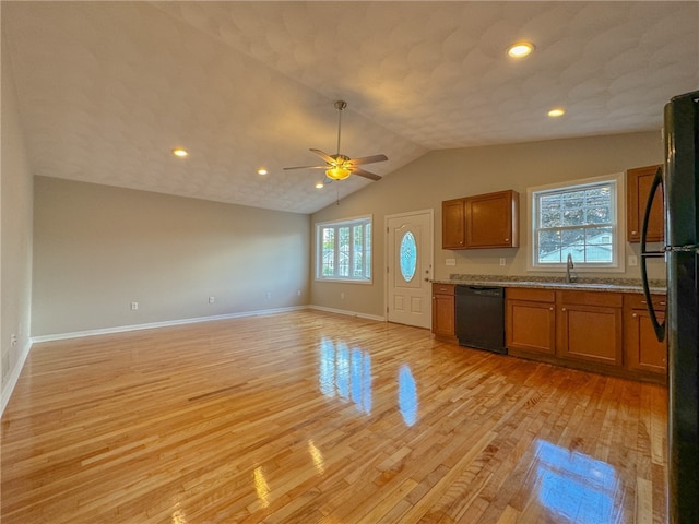 kitchen featuring a healthy amount of sunlight, black appliances, and light hardwood / wood-style floors