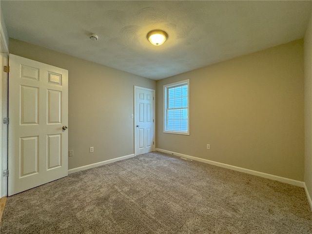 unfurnished bedroom featuring a textured ceiling and carpet flooring