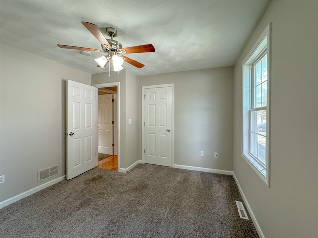 unfurnished bedroom featuring carpet and ceiling fan