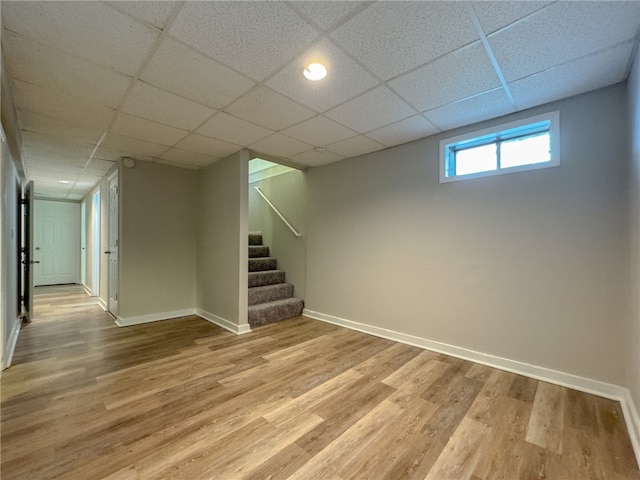 basement with light wood-type flooring and a drop ceiling