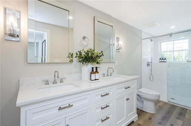 bathroom with walk in shower, vanity, toilet, and wood-type flooring