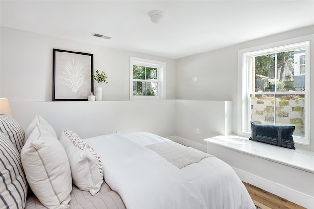 bedroom with hardwood / wood-style floors