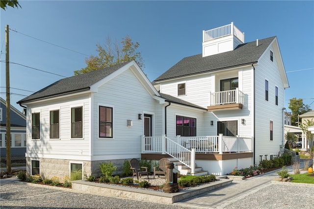 view of front of house featuring a balcony