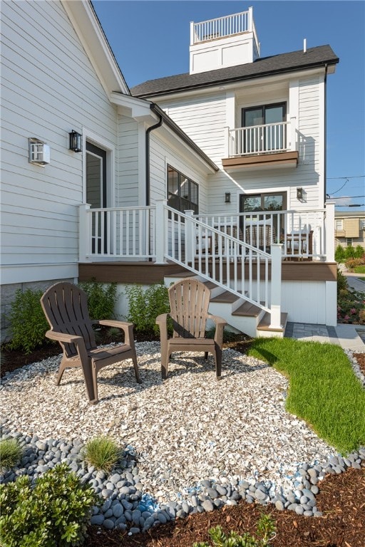 back of house with a balcony