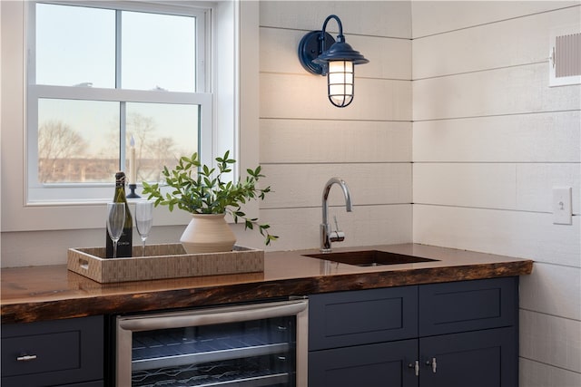 bar with beverage cooler and sink