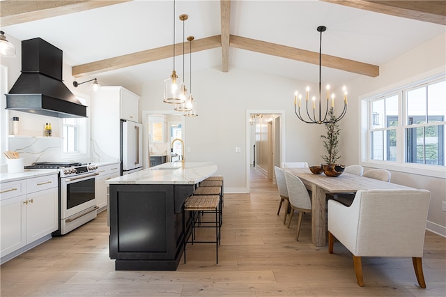 kitchen featuring light hardwood / wood-style floors, an island with sink, high end appliances, vaulted ceiling with beams, and premium range hood