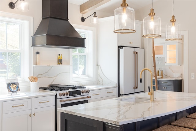 kitchen featuring white cabinets, premium appliances, pendant lighting, custom exhaust hood, and a healthy amount of sunlight