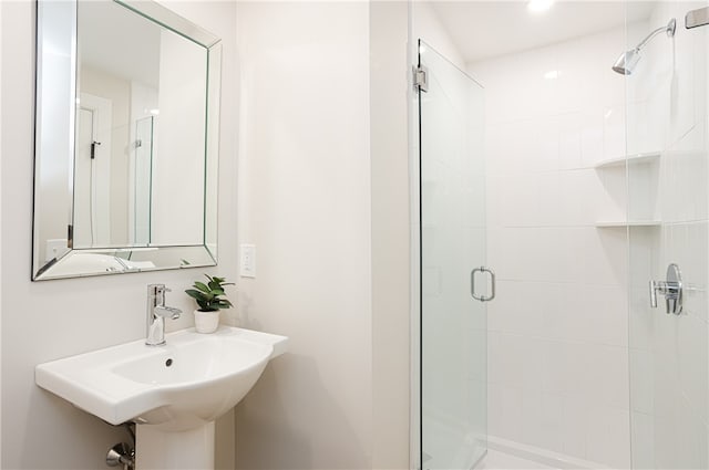 bathroom featuring sink and an enclosed shower