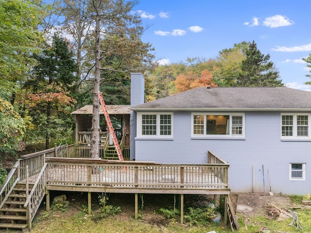 rear view of property featuring a wooden deck