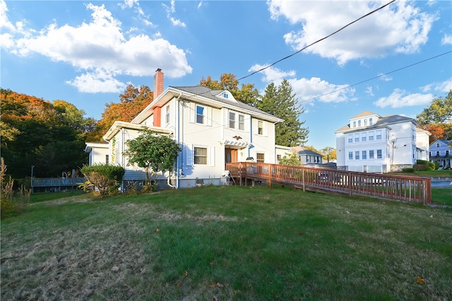 rear view of house featuring a lawn