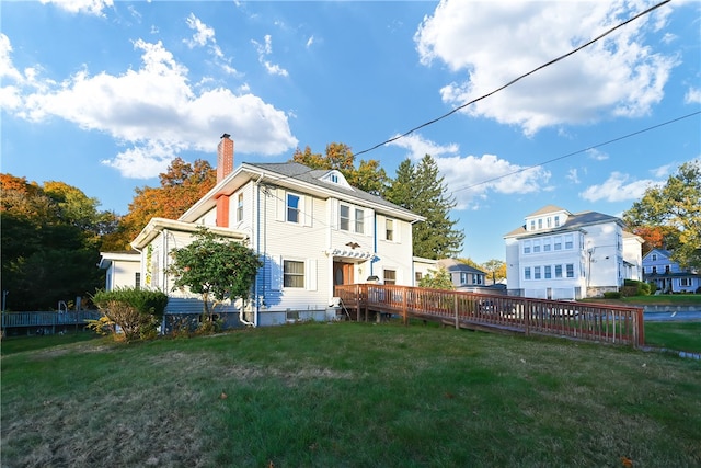 rear view of house featuring a yard