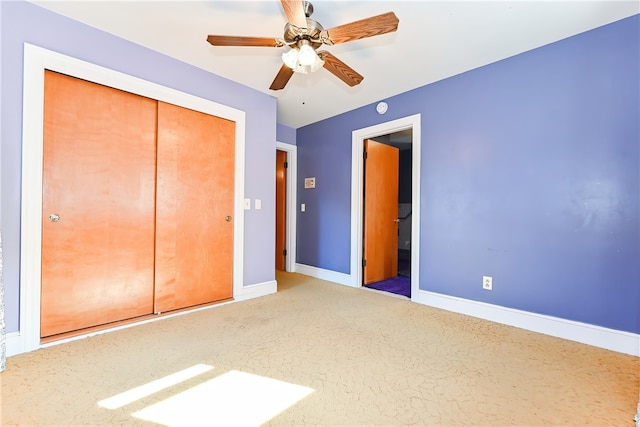 unfurnished bedroom featuring a closet, carpet, and ceiling fan