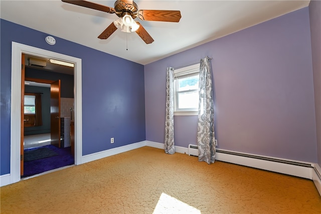 carpeted spare room featuring a baseboard radiator and ceiling fan