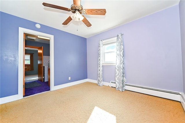 carpeted spare room with ceiling fan and baseboard heating