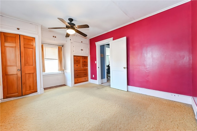 unfurnished bedroom with crown molding, light carpet, and ceiling fan