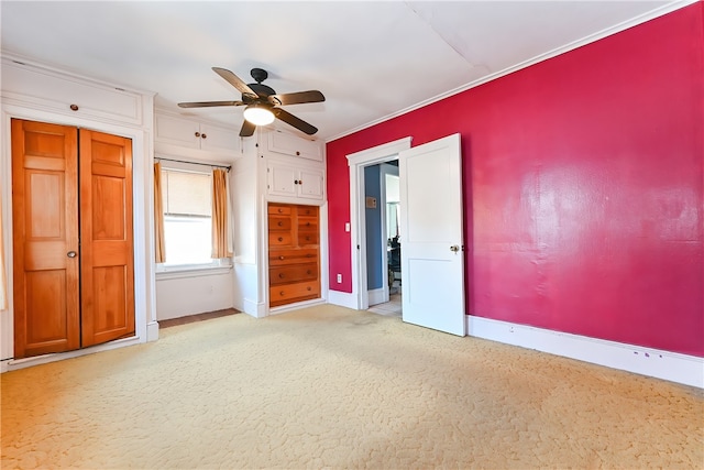 unfurnished bedroom featuring crown molding, light carpet, and ceiling fan