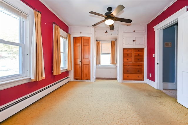 spare room with a baseboard heating unit, ceiling fan, and a wealth of natural light