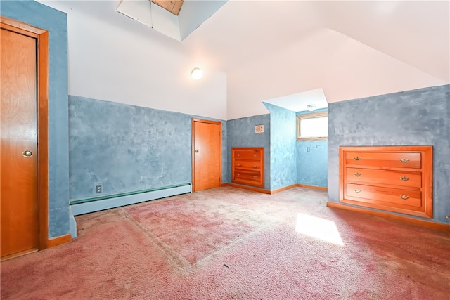 unfurnished bedroom with carpet, a baseboard heating unit, and high vaulted ceiling