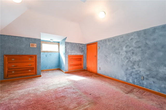 unfurnished bedroom featuring carpet and high vaulted ceiling