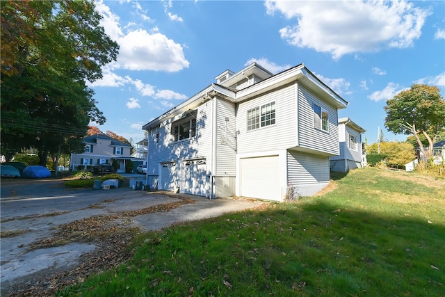 view of property exterior with a yard and a garage