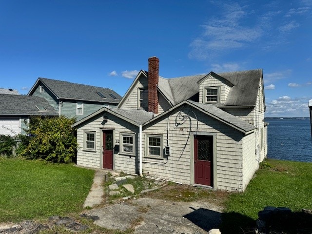 view of front of house featuring a front yard and a water view