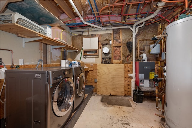 washroom with washer and dryer and gas water heater