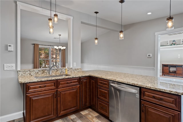 kitchen featuring sink, dishwasher, and decorative light fixtures