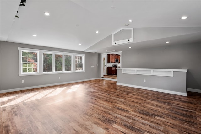 unfurnished living room with lofted ceiling and dark hardwood / wood-style flooring