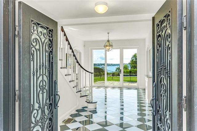 tiled foyer featuring a water view