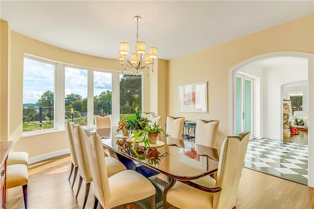 dining area featuring a notable chandelier and light hardwood / wood-style flooring