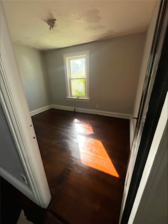 spare room featuring dark hardwood / wood-style flooring