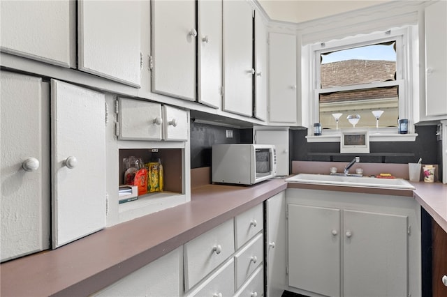 kitchen with white cabinets and sink