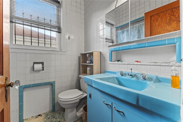 bathroom with vanity, tile walls, tile patterned flooring, and toilet