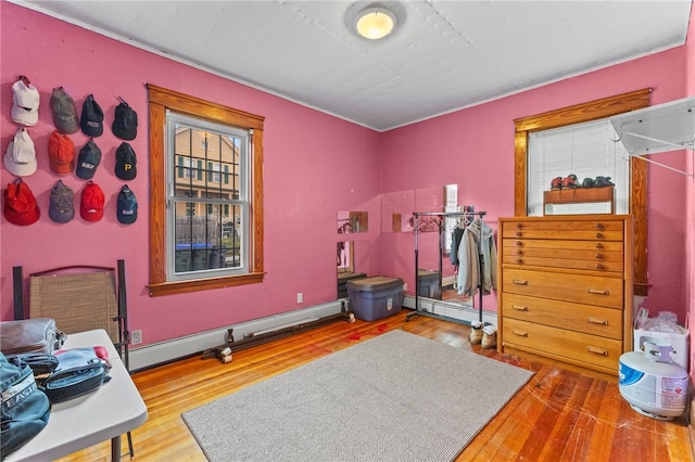 interior space with hardwood / wood-style floors and a baseboard heating unit