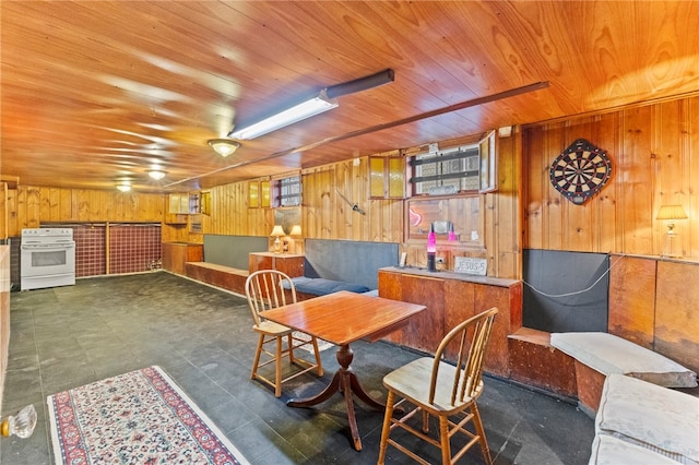 dining room with wooden walls and wooden ceiling