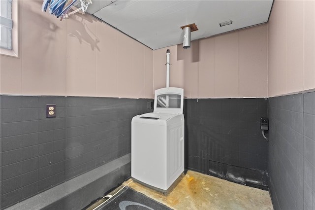 bathroom featuring concrete floors and washer / clothes dryer